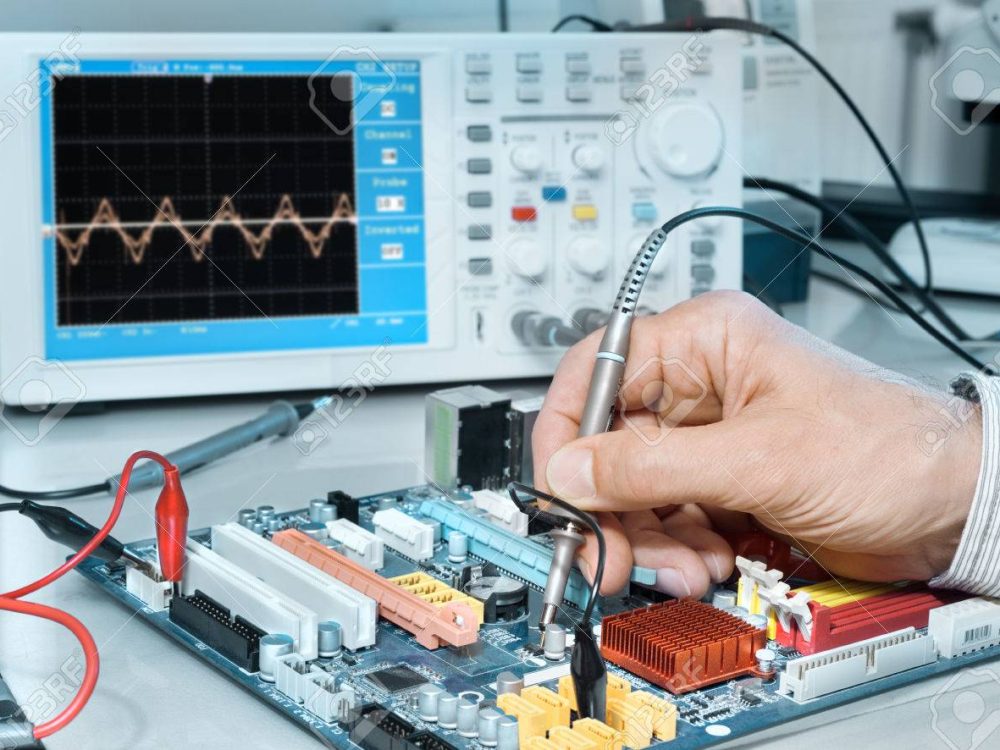 Electronics repair service, hands of senior tech reparing an electronic circuit